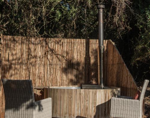 a fence with two chairs and a light pole at Thunzi Bush Lodge in Beachview