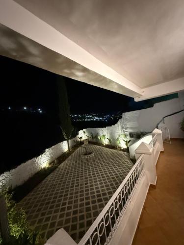 a balcony with a view of the water at night at Casa Hugo in Chefchaouene
