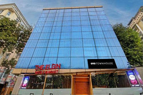 a tall glass building with a sign on it at Townhouse Refresh in Kolkata