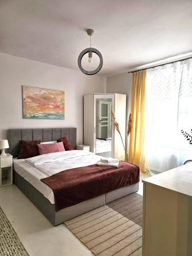 a bedroom with a large bed and a window at Tabago Studio 36 Brzeg Chopina in Brzeg