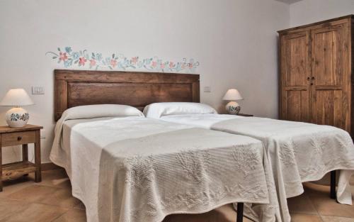a bedroom with two beds with white blankets at Sea View Grande Pevero 8 in Porto Cervo