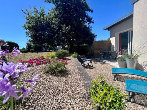 a garden with benches and flowers in a yard at BRIT HOTEL Lannion-Perros Guirec in Lannion