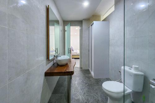 a bathroom with a toilet and a sink and a mirror at Emilia 1 Bedroom Apartment Seminyak by Nagisa Bali in Kerobokan