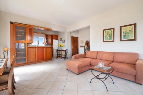a living room with a couch and a table at Nektar Luxury Apartment in Stalos