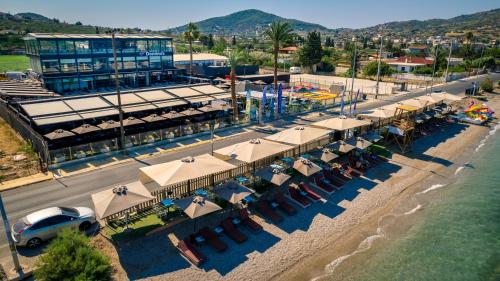 an overhead view of a beach with umbrellas and chairs at Sea View Serenity Βeachfront & Pool 105 in Salamís