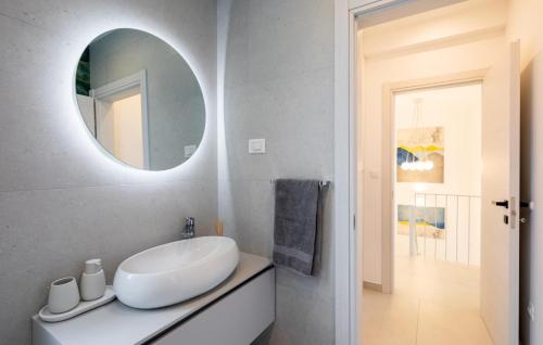 a white bathroom with a sink and a mirror at VILLA MON AMOUR by Villas Guide in Blato