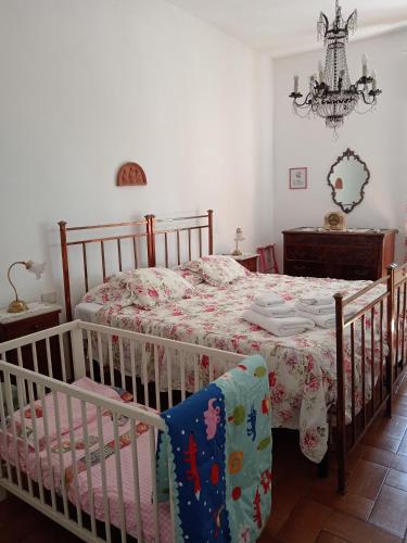 a bedroom with two cribs and a bed with a table at Villa Remignoli in San Gimignano