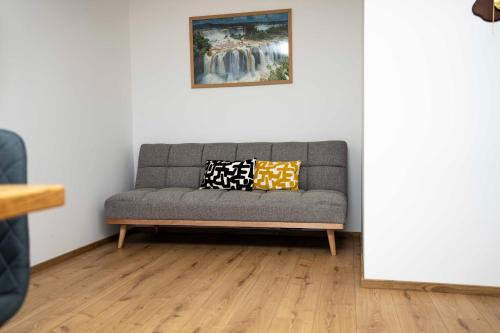 a couch with pillows on it in a living room at Holiday House Konuško in Šmarje pri Jelšah