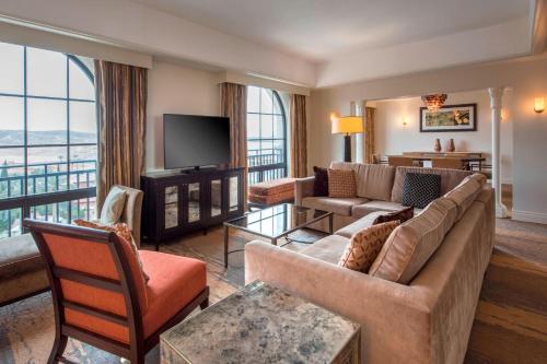 a living room with a couch and a television at The Westin Lake Las Vegas Resort & Spa in Las Vegas