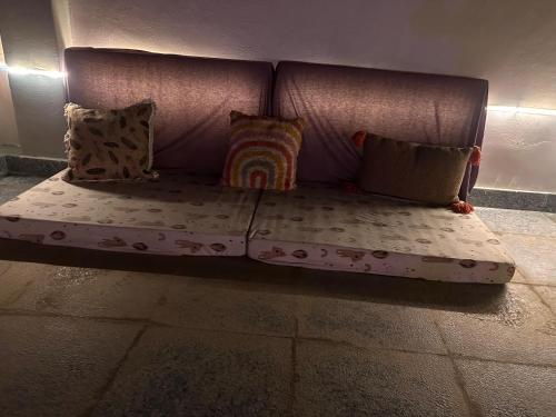 a couch with pillows sitting on the floor at THS Home Stay in Varanasi