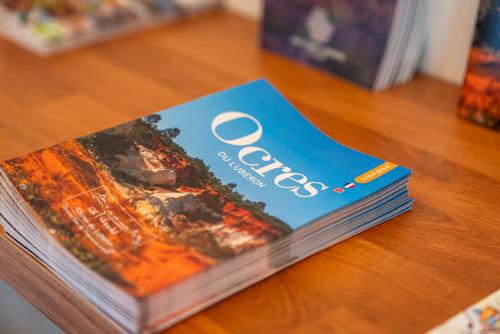 a book sitting on top of a table at Hotel Les Ambres in Roussillon