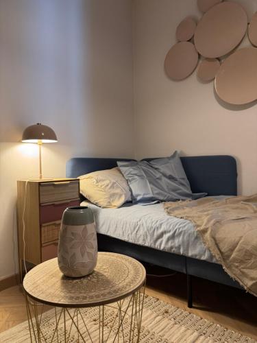 a bedroom with a bed and a table with a table at Casino Apartment in Ostend