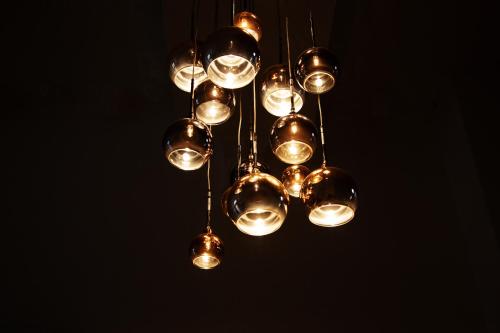 a cluster of lights hanging from a ceiling at The Montana in Torquay
