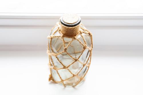 a glass bottle with a rope handle on a window at The Montana in Torquay