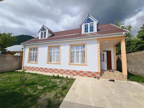 a small white house with a red roof at Aksn new small villa in Gabala