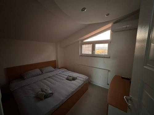 a bedroom with a bed with two teddy bears on it at Apartments Filip in Ohrid
