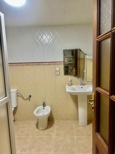 a bathroom with a toilet and a sink at Tidal Tranquillity Costal Escape in Asilah
