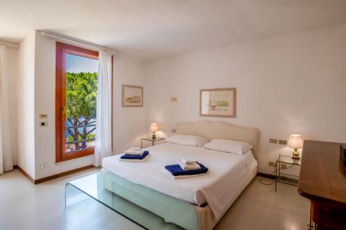 En eller flere senge i et værelse på Villa Elba Sunset