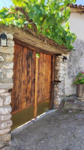 a wooden door on the side of a building at Μονόχωρος με αυλή in Vrasná