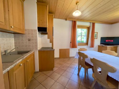 a kitchen with a table and a dining room at Bait Ables in Livigno