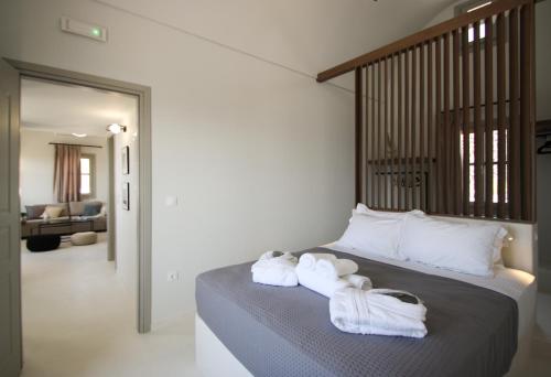 a bedroom with two towels on a bed at Airy Suites Santorini in Oia