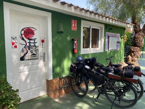 a couple of bikes parked outside of a green building at La Casa Verde in Murcia
