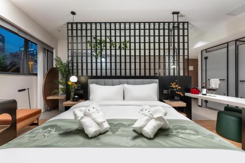 a bedroom with two towels on a bed at KSpace KaiShi hotel in Guangzhou