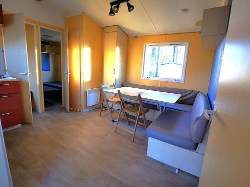 a room with a table and chairs and a kitchen at MH First 6pers 30min PuyduFou HellFest in La Boissière-de-Montaigu