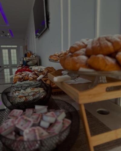 a bunch of breads and pastries on a table at Kompleksi Exalco-Al in Shkodër