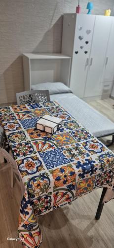 a quilt on a bed in a room at Sweet Home Sofia in Barletta