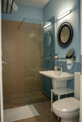 a bathroom with a toilet and a sink and a shower at Halta Pescăruş Accommodation in Douăzeci şi Trei August
