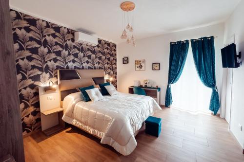 a bedroom with a large bed with blue curtains at Bio B&B La Scoperta del Pollino in Laino Castello