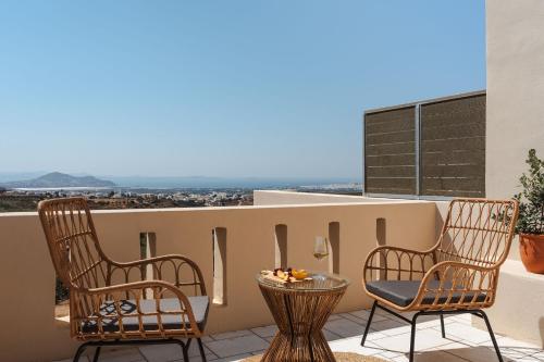 two chairs and a table on a balcony with a view at Naxos Tower in Naxos Chora