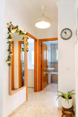 a bathroom with a mirror and a clock on the wall at RIO SECO LOFT BEACH- HOME RENt MALAGA in Torre del Mar