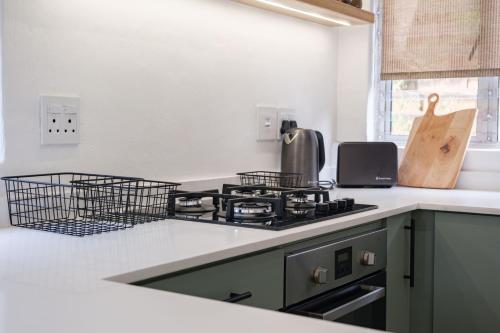 a kitchen counter with a stove and a sink at Ocean Breeze Escape in Ballito