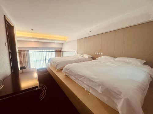 a hotel room with two beds and a window at Chateau Lizhi Hotel in Beijing