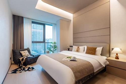 a bedroom with a large bed and a large window at 故渝里两室两卫 in Chongqing
