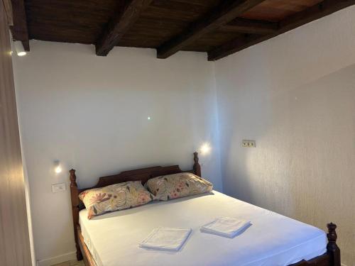 a bedroom with a bed with two towels on it at Apartments with pool Maraska in Brela