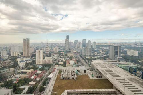 a view of a city from the top of a building at Balai ni Boss - Cozy Modern 1BR in Victoria Sports Tower in Manila