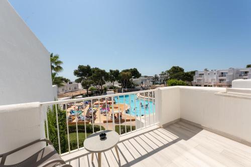a balcony with a view of a swimming pool at Hotel Club Es Talaial in Cala d´Or