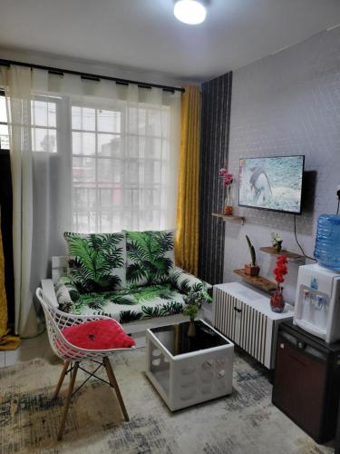 a living room with a couch and a chair at ALMASI - Utawala in Nairobi