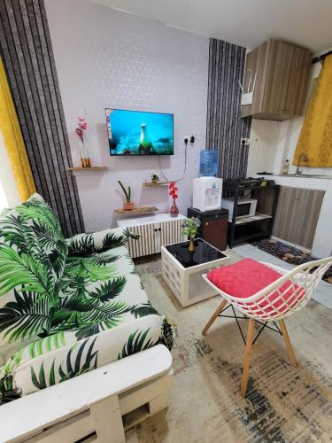 a living room with a couch and a chair at ALMASI - Utawala in Nairobi