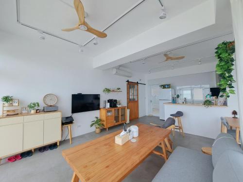 a living room with a wooden table and a couch at 與浪共舞 in Xiyu