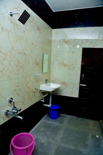 a bathroom with a sink and a faucet at KSM Muthra residency in Tiruchchendūr