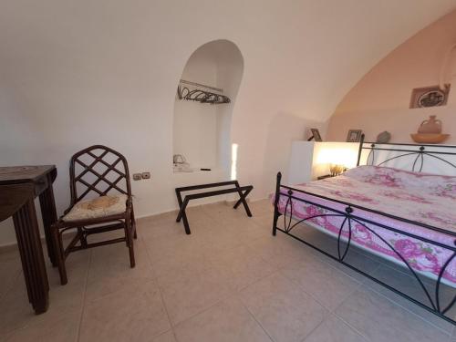 a bedroom with a bed and a desk and a chair at Mani Spot Katerina in Poliána