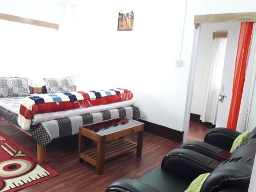 a living room with a couch and a table at Bliss Homestay in Tawang