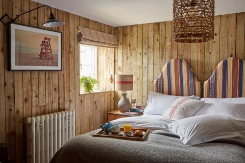 a bedroom with a bed with a tray of food on it at Artist Residence Cornwall in Penzance
