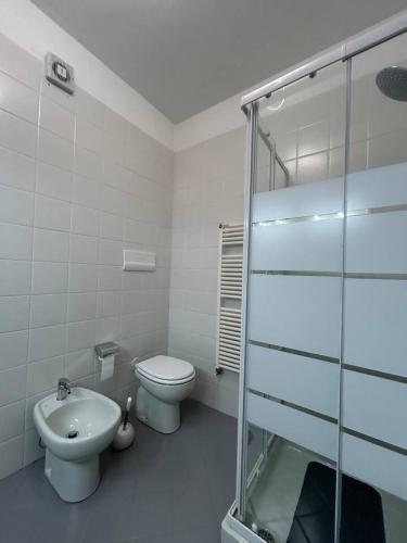 a bathroom with a toilet and a glass shower at Residenza Kristall Lago in Desenzano del Garda