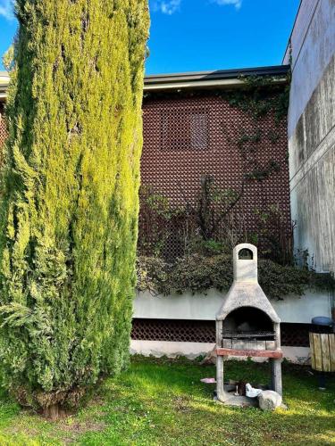a bird house sitting in the grass next to a tree at Residenza Kristall Lago in Desenzano del Garda