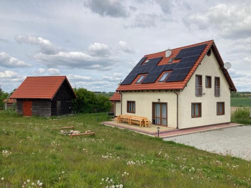 a house with solar panels on the roof at Pęglity jezioro in Gietrzwałd